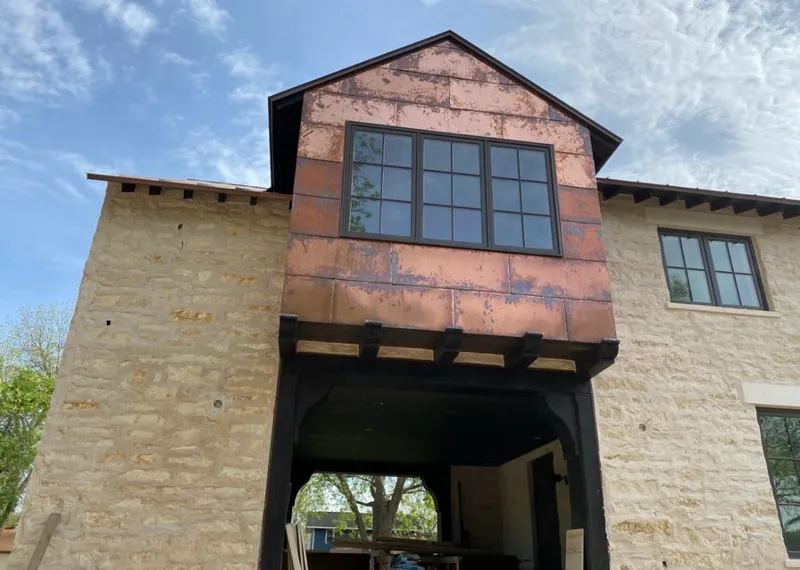 Copper metal panel facade on a stone building for Roof Repair in Libertyville